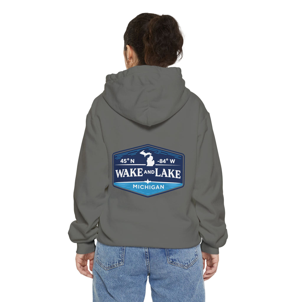 Model wearing the Wake and Lake Michigan Shield Hoodie – Premium in Grey, back view showing the 45°N -84°W coordinate badge.