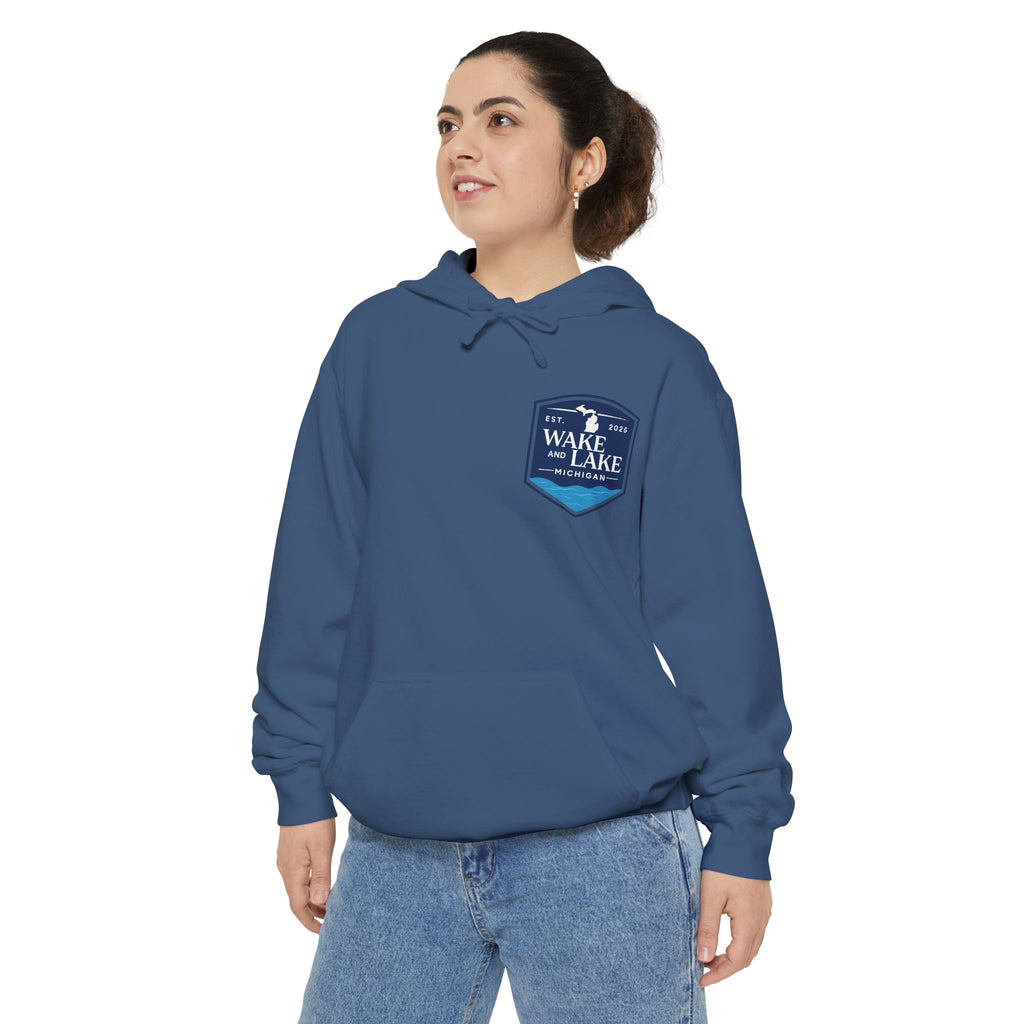 Model wearing the Wake and Lake Michigan Shield Hoodie – Premium in True Navy, front view showing the left-chest shield badge.
