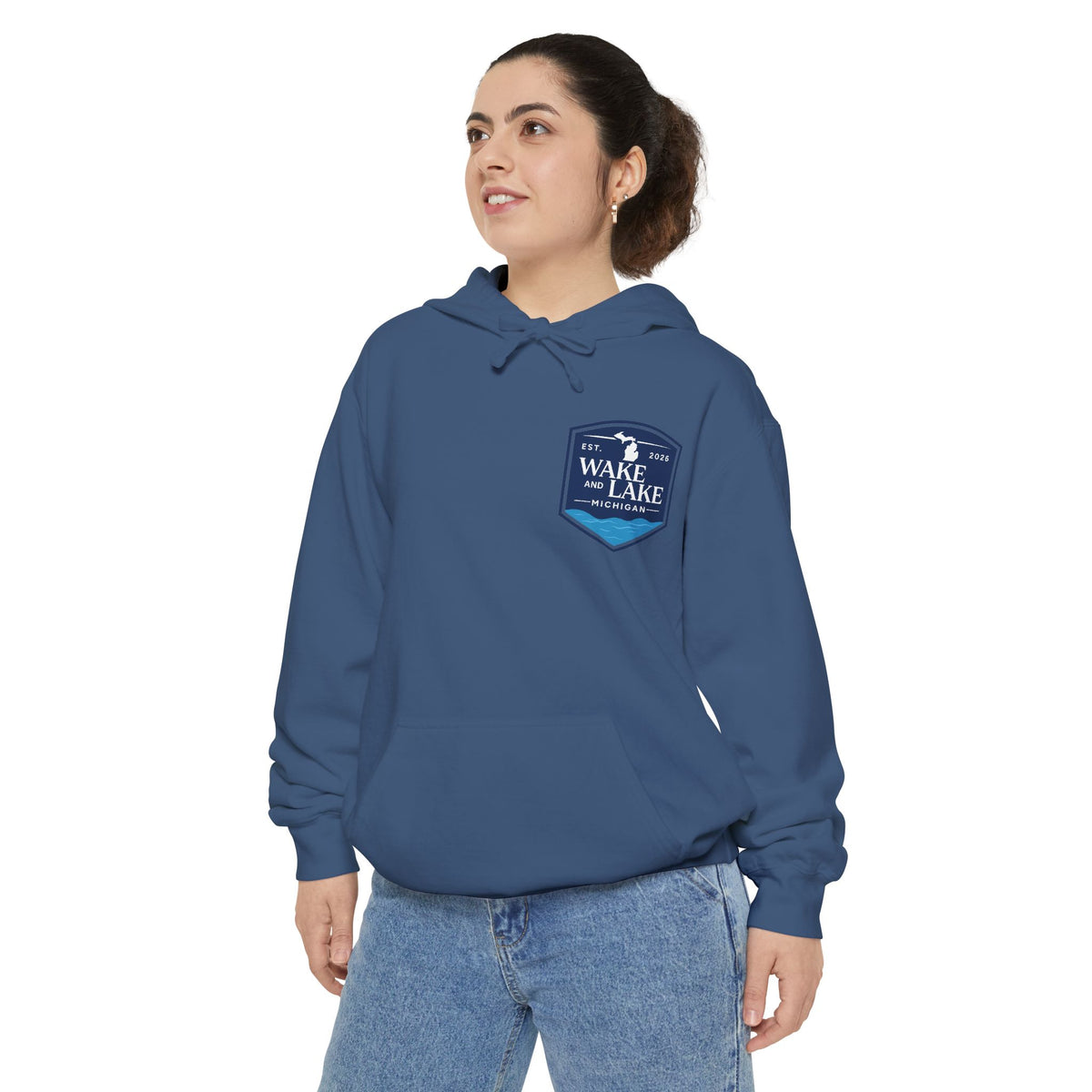 Model wearing the Wake and Lake Michigan Shield Hoodie – Premium in True Navy, front view showing the left-chest shield badge.