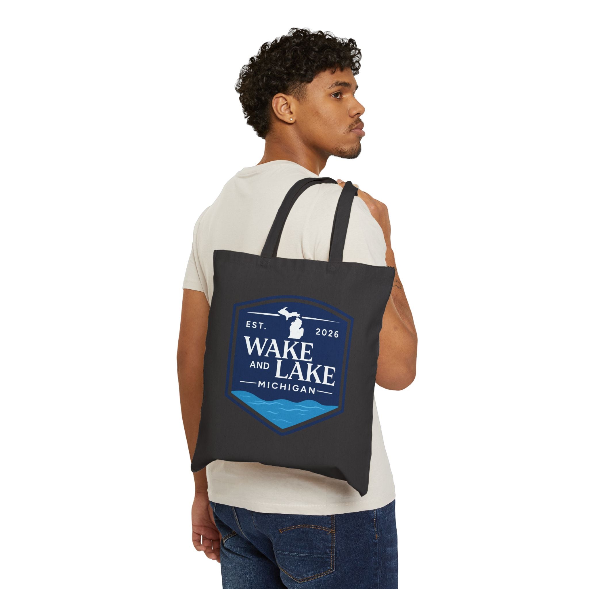 Wake and Lake Michigan Canvas Tote Bag at a Great Lakes shoreline
Michigan shield canvas carryall tote for lake days
Durable Michigan lake bag with Wake and Lake branding
Great Lakes canvas tote bag with Michigan shield graphic
