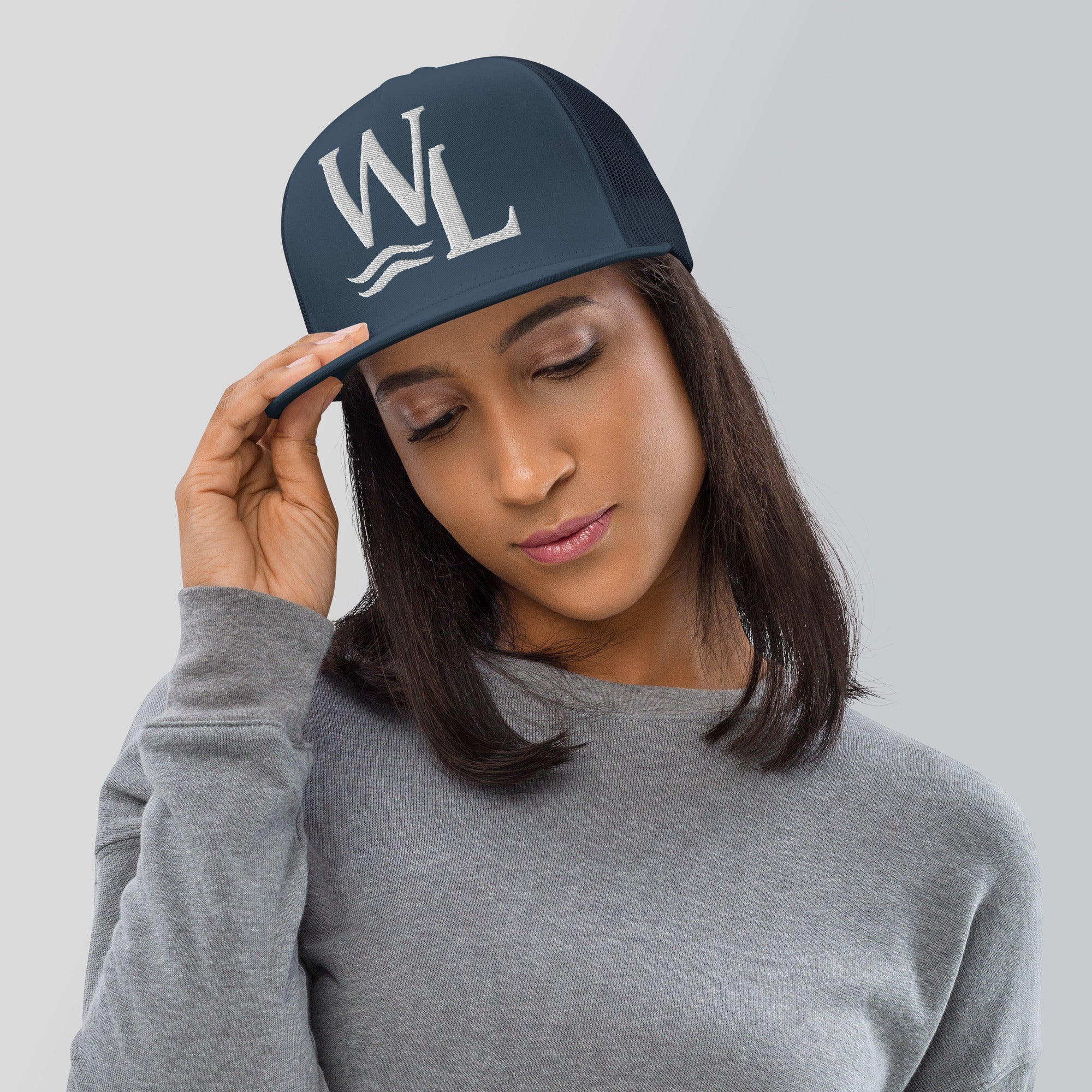 Wake and Lake WL Monogram Trucker Hat worn on a boat at sunrise
Breathable mesh trucker cap with WL monogram for lake life
Adjustable lake trucker hat with Wake and Lake branding
Classic snapback mesh hat with WL logo for boating
