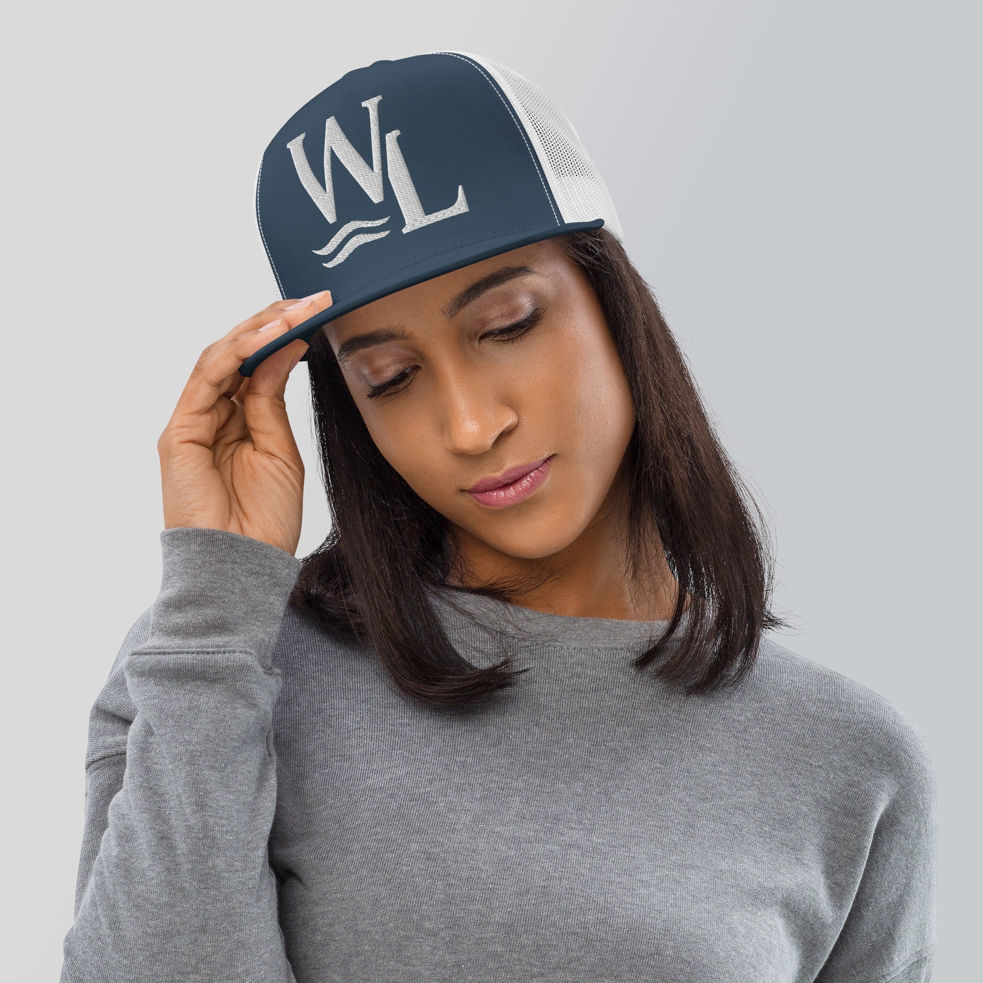 Wake and Lake WL Monogram Trucker Hat worn on a boat at sunrise
Breathable mesh trucker cap with WL monogram for lake life
Adjustable lake trucker hat with Wake and Lake branding
Classic snapback mesh hat with WL logo for boating
