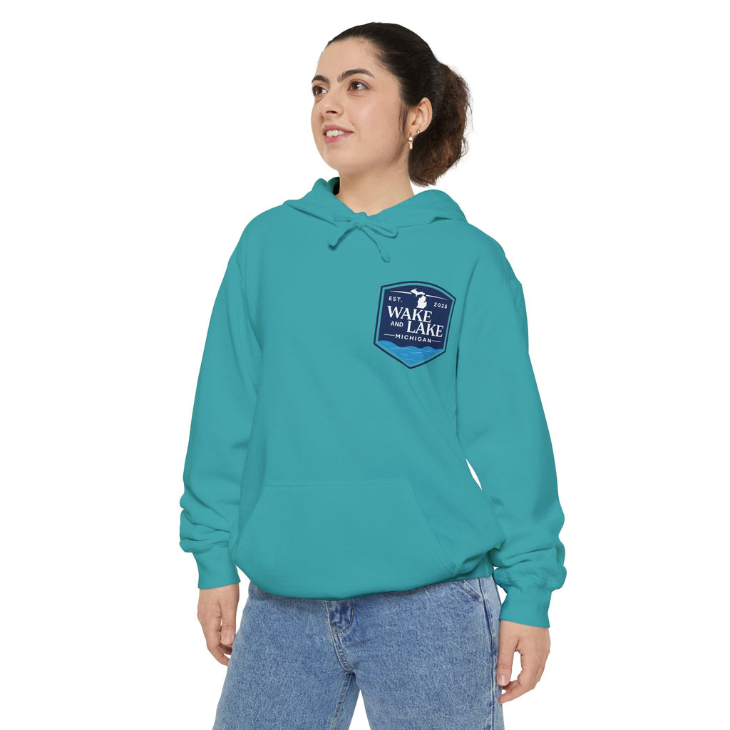 Model wearing the Wake and Lake Michigan Shield Hoodie – Premium in Seafoam, front view showing the left-chest shield badge.