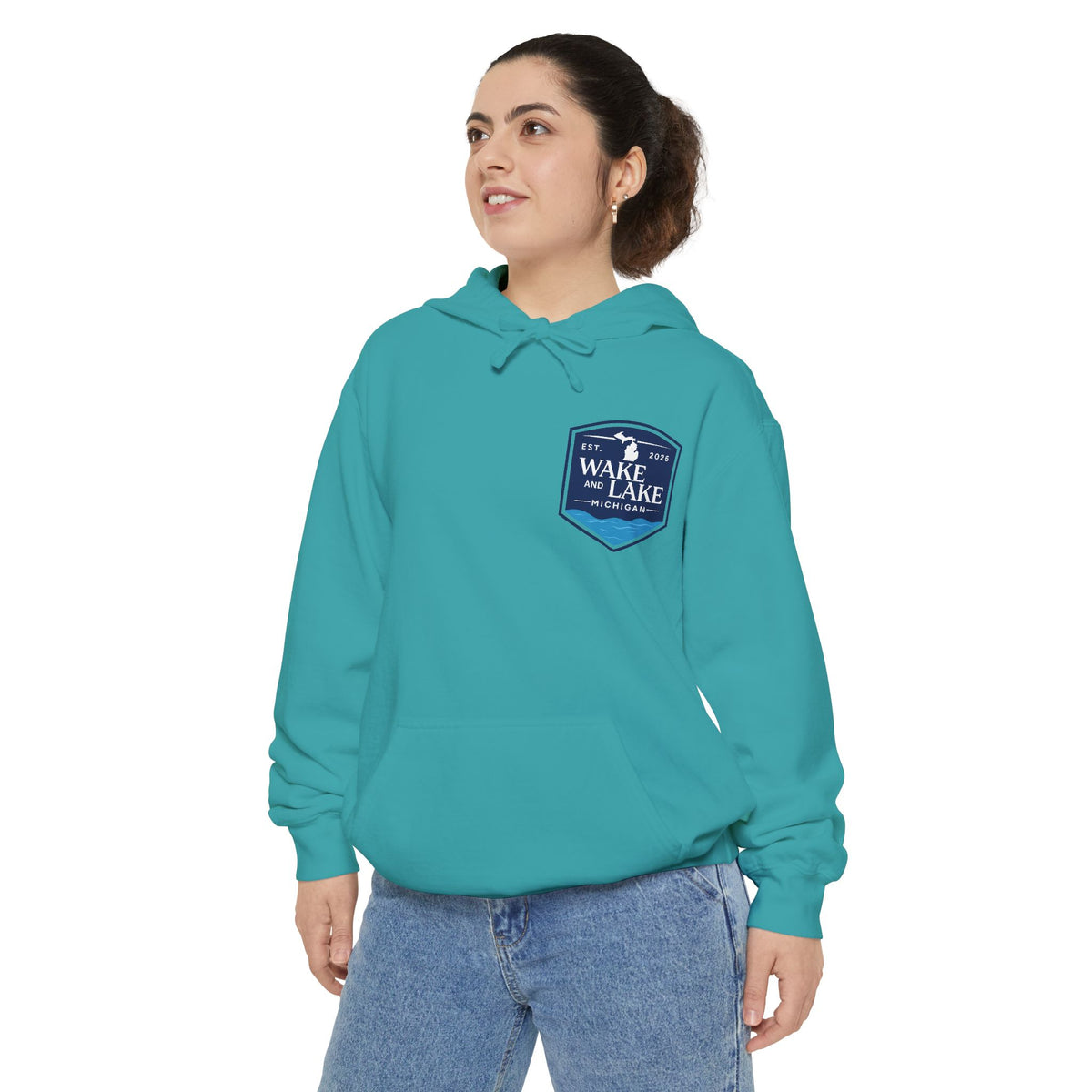 Model wearing the Wake and Lake Michigan Shield Hoodie – Premium in Seafoam, front view showing the left-chest shield badge.