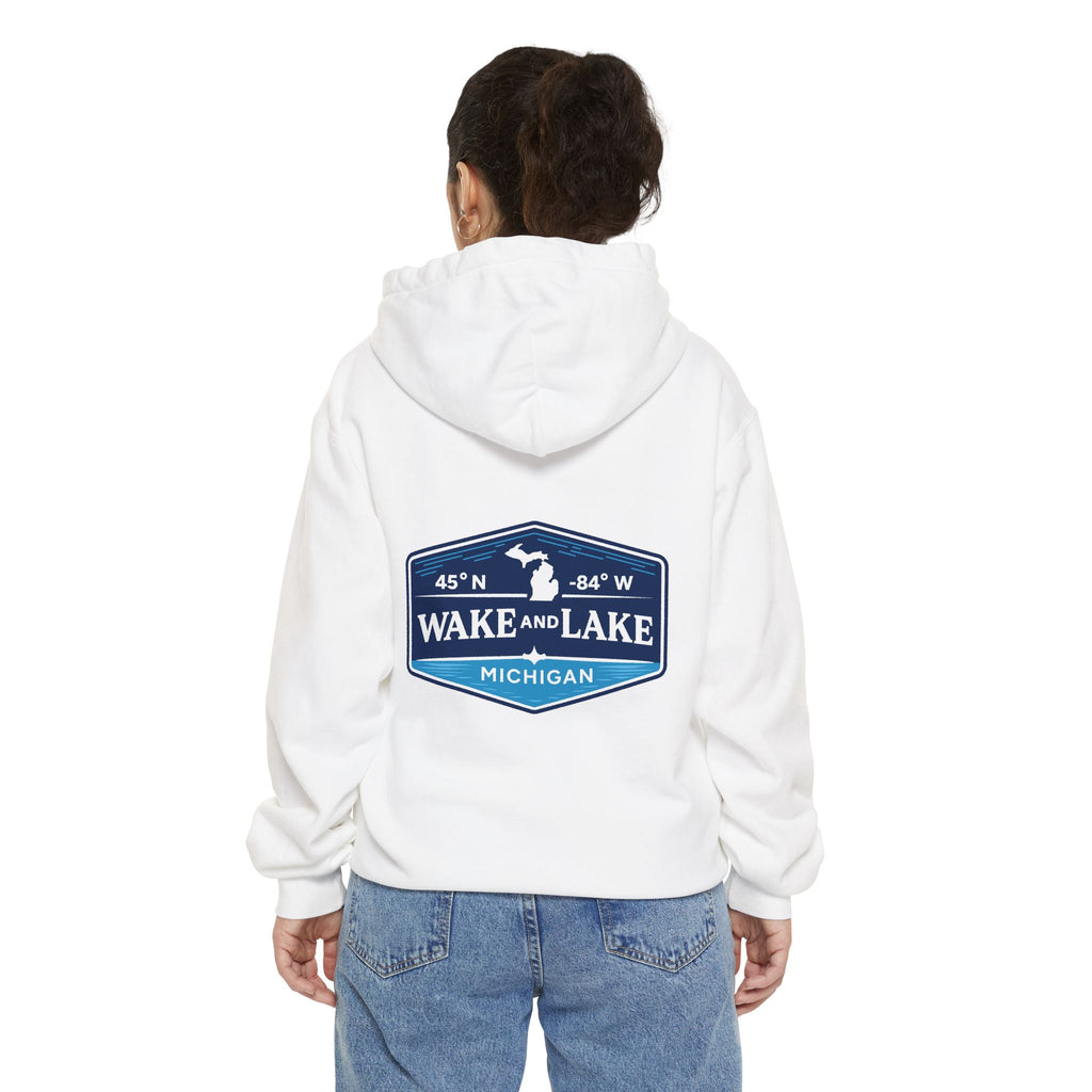 Model wearing the Wake and Lake Michigan Shield Hoodie – Premium in White, back view showing the 45°N -84°W coordinate badge.