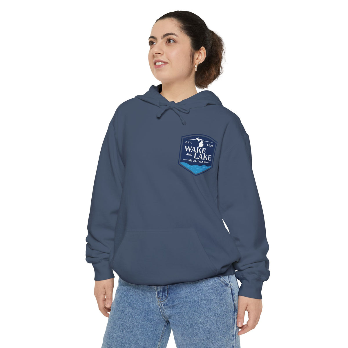 Model wearing the Wake and Lake Michigan Shield Hoodie – Premium in Denim, front view showing the left-chest shield badge.