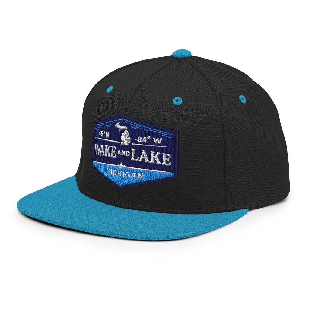Classic Snap Back Hat, Wake and Lake Coordinate Badge, black and teal, front view