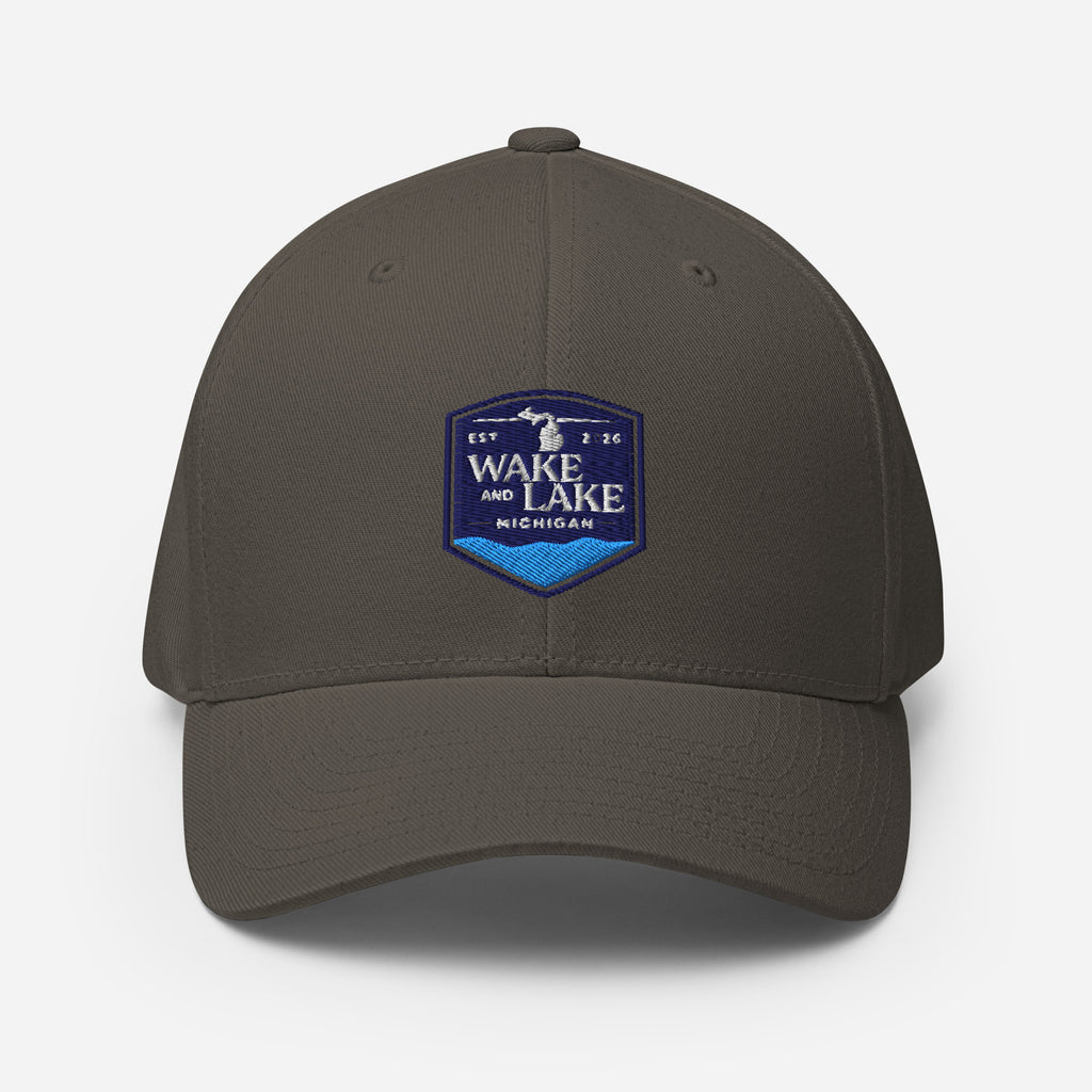 Wake and Lake Michigan Shield FlexFit Hat, dark grey with Coordinate badge on the front, and Circle Crest logo on the back, front view