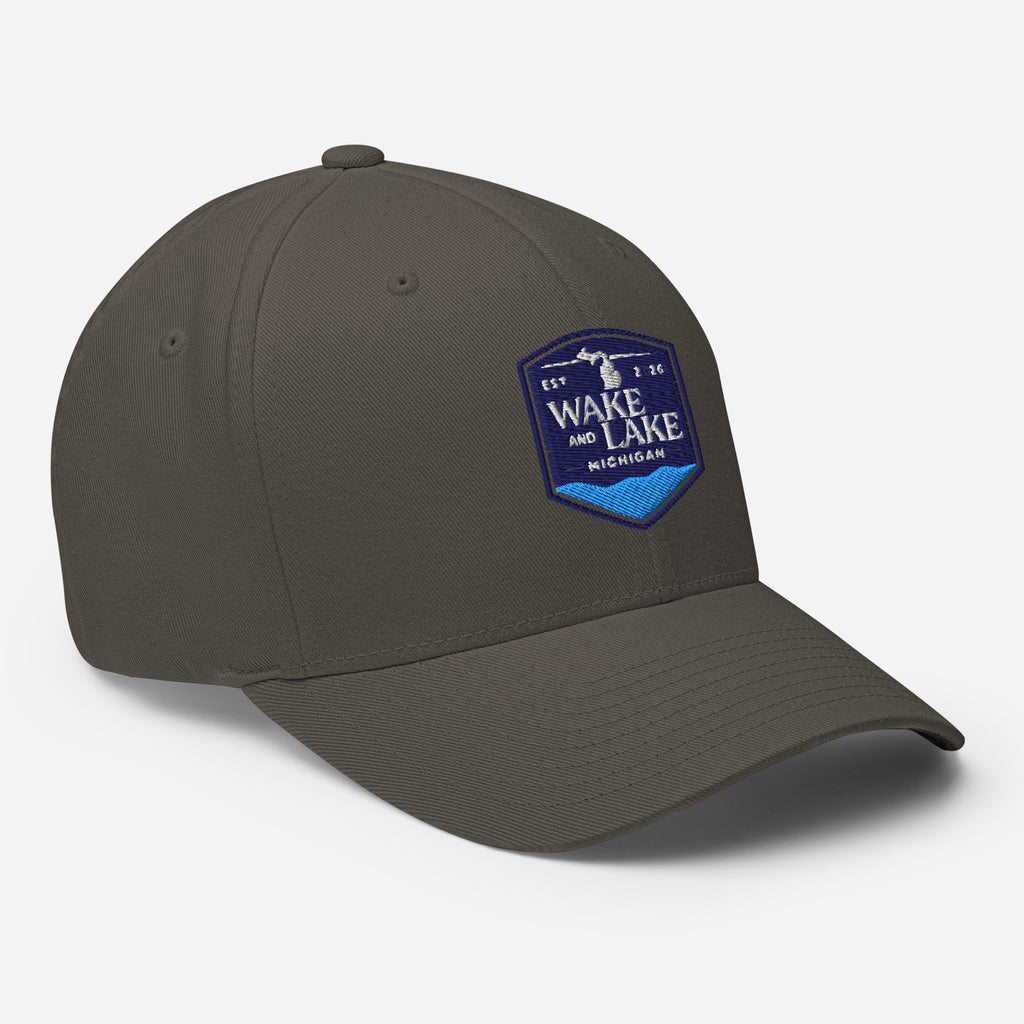 Wake and Lake Michigan Shield FlexFit Hat, dark grey with Coordinate badge on the front, and Circle Crest logo on the back, front view