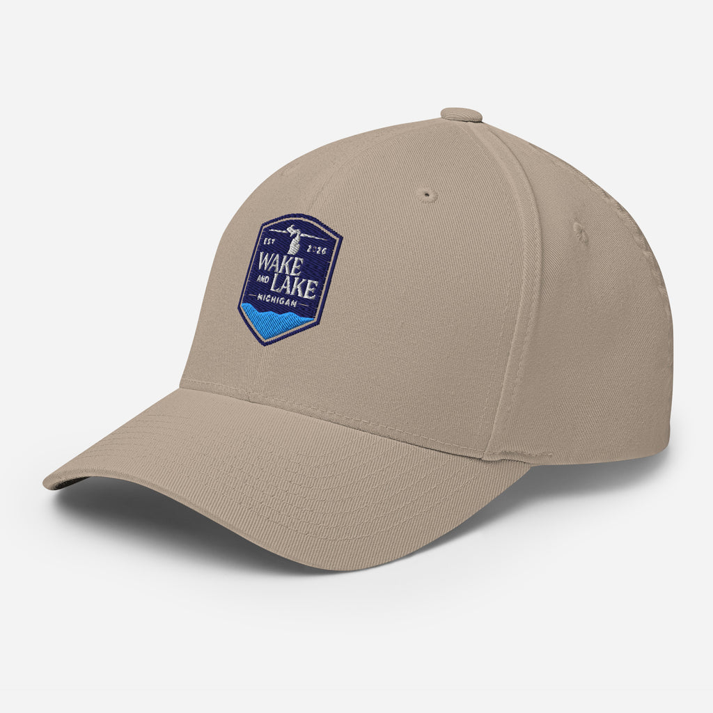 Wake and Lake Michigan Shield FlexFit Hat, khaki with Coordinate badge on the front, and Circle Crest logo on the back, front view