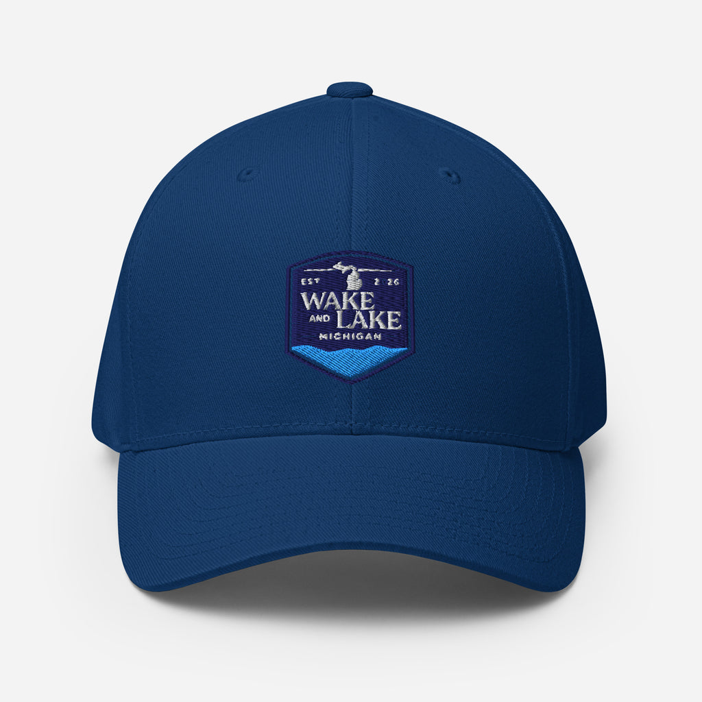 Wake and Lake Michigan Shield FlexFit Hat, royal blue with Coordinate badge on the front, and Circle Crest logo on the back, front view