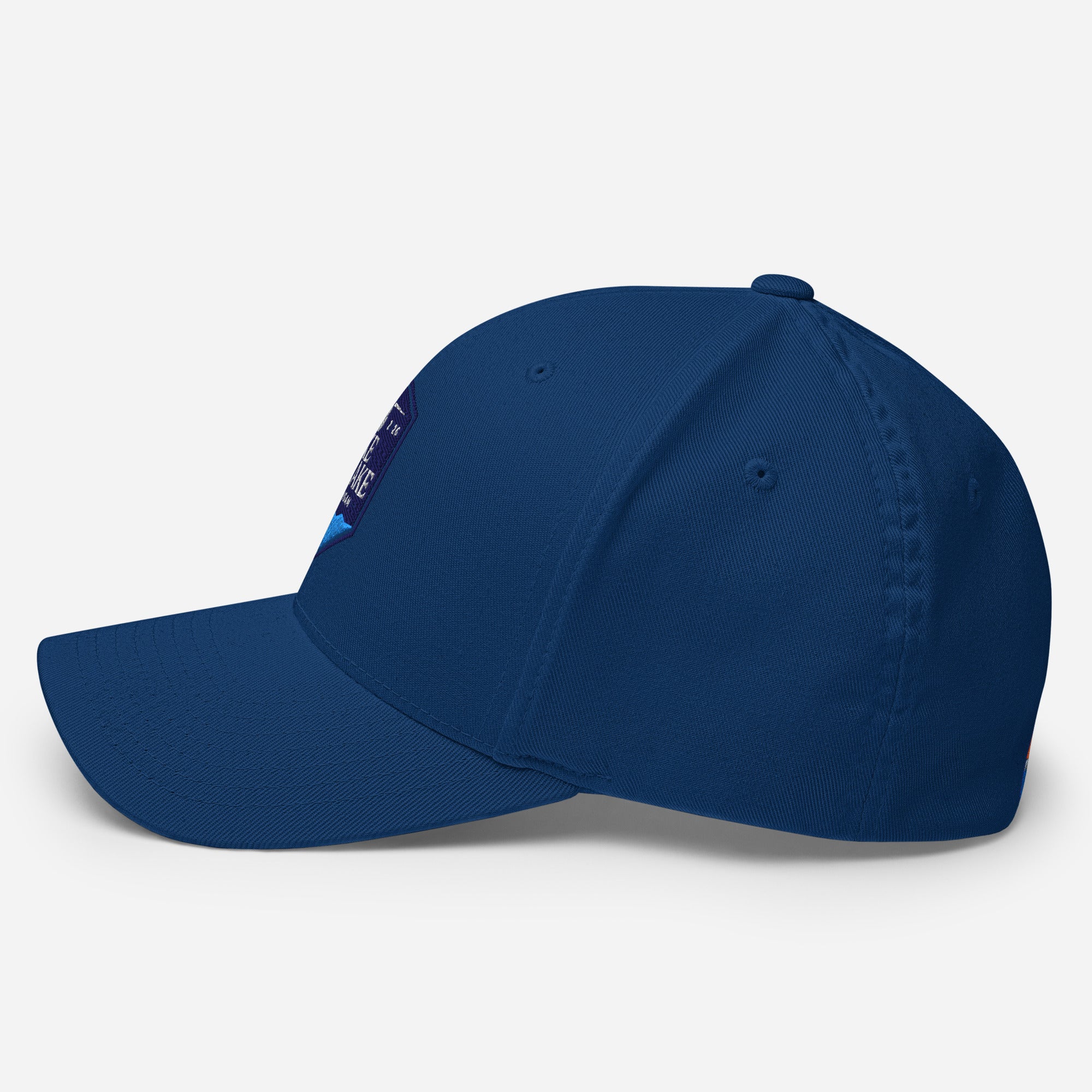 Wake and Lake Michigan Shield FlexFit Hat, royal blue with Coordinate badge on the front, and Circle Crest logo on the back, side view