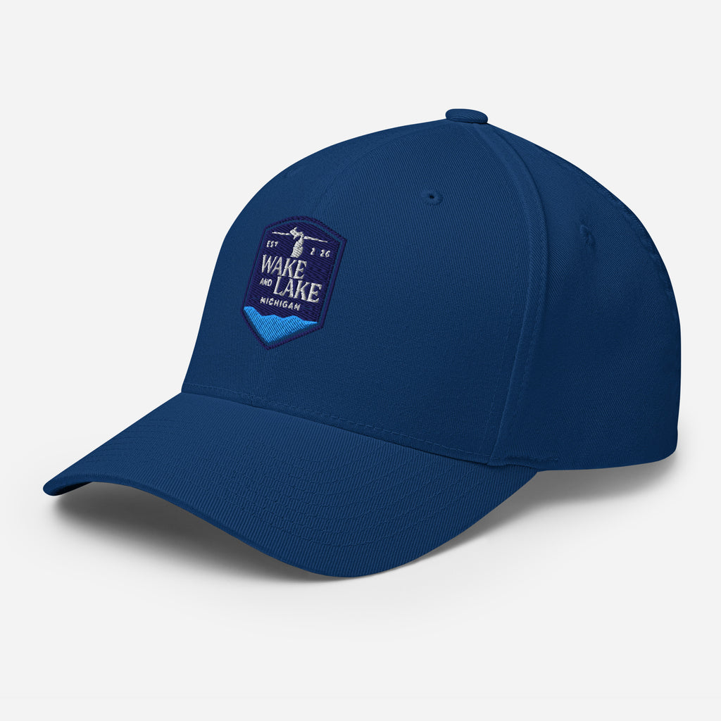Wake and Lake Michigan Shield FlexFit Hat, royal blue with Coordinate badge on the front, and Circle Crest logo on the back, front view