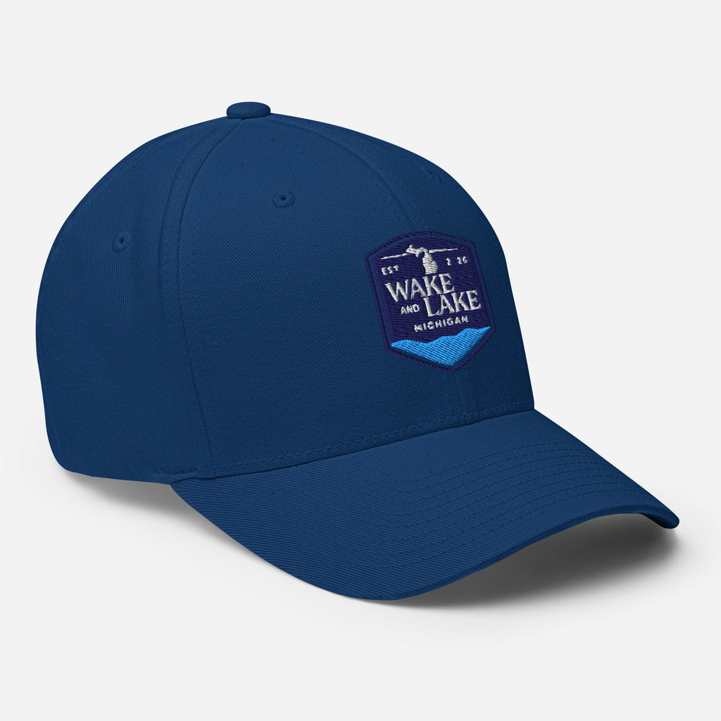 Wake and Lake Michigan Shield FlexFit Hat, royal blue with Coordinate badge on the front, and Circle Crest logo on the back, front view